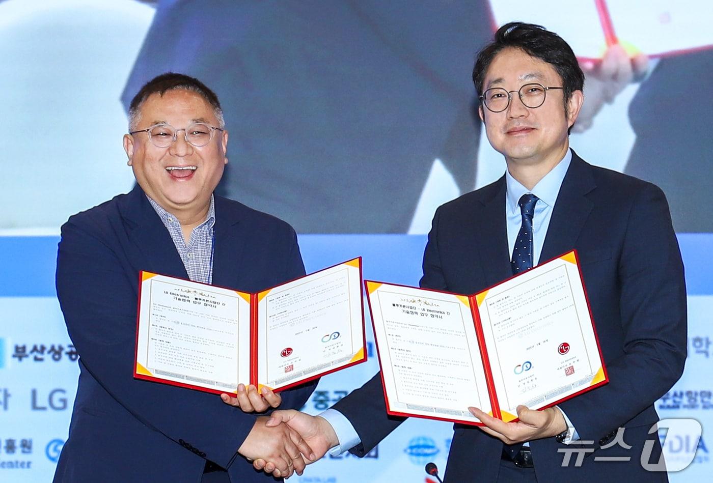 LG전자가 26일 부산 벡스코에서 서울대학교 블루카본사업단과 '블루카본 산업 활성화를 위한 기술 교류' 업무 협약을 체결했다. 서울대학교 블루카본사업단 김종성 단장(왼쪽)과 LG전자 김영석 HS기능성소재사업실장이 기념 사진을 촬영하고 있다(LG전자 제공). ⓒ 뉴스1