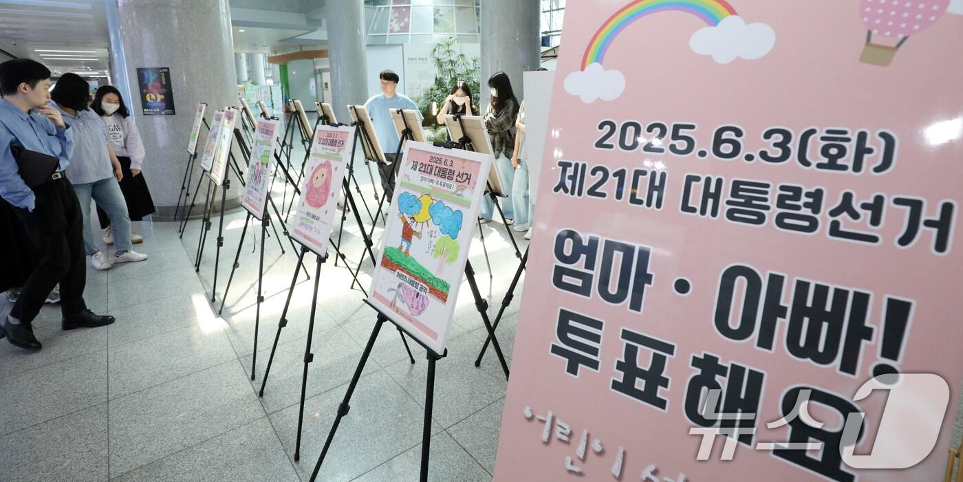 제21대 대통령 선거를 일주일 앞둔 지난 27일 전북 전주시 전북특별자치도청 로비에서 열린 전북특별자치도선거관리위원회 주최 '엄마·아빠 투표해요' 전시회를 찾은 시민들이 관람을 하고 있다. 2025.5.27/뉴스1 ⓒ News1 유경석 기자