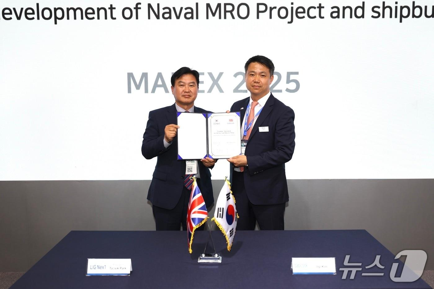 29일 국제해양방위산업전(MADEX 2025) 전시회 현장에서 ‘함정 MRO 사업개발 및 신규 함정 건조사업 공동참여 프로젝트 추진을 위한 협력합의서’를 체결한 박태식 LIG넥스원 미사일시스템사업부문장(좌측)과 일기 킴 밥콕 마린 최고영업책임자(우측)가 기념사진을 촬영하고 있다.(LIG넥스원 제공) 