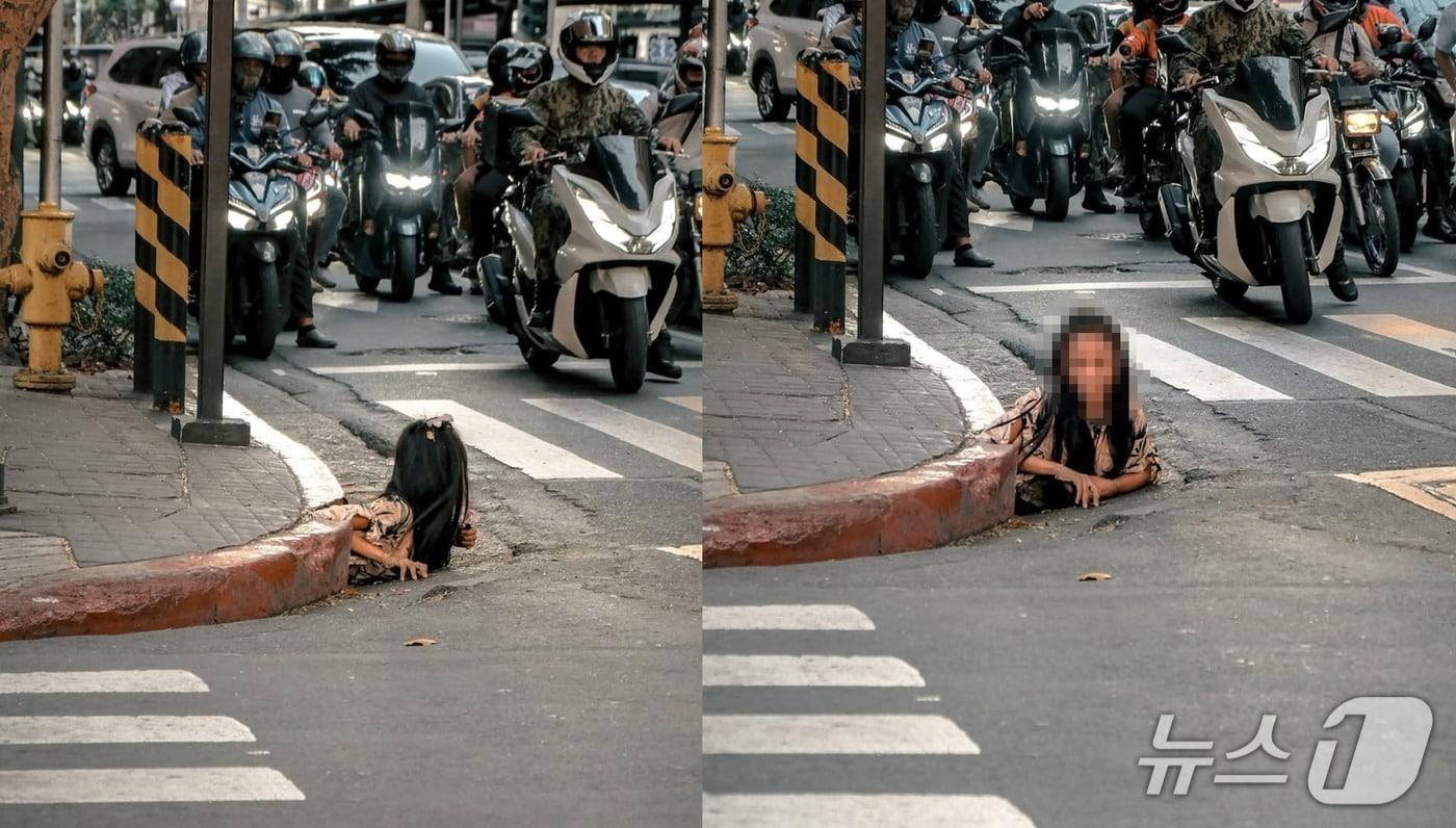 지난 26일 필리핀 미카타시의 번화가 모퉁이 하수구에서 여성 노숙자가 기어 나오는 모습. &#40;사진은 William Roberts 인스타그램 갈무리&#41;