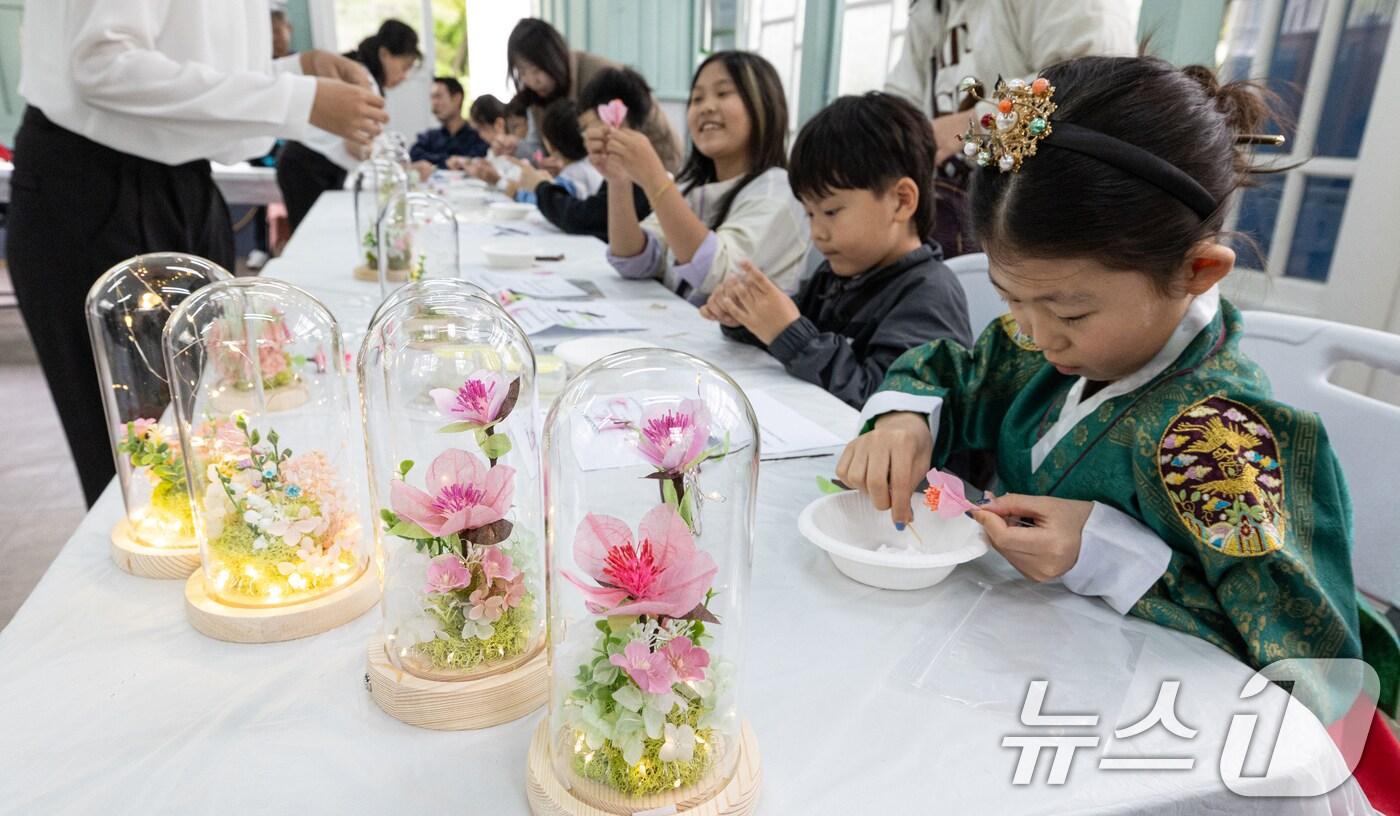 본문 이미지 - 6일 오후 서울 종로구 창경궁 대온실 교육관에서 열린 '효의 궁, 창경궁에서 정조의 효심을 배우다' 행사에 참여한 어린이들이 복숭아꽃 효도등 만들기 체험을 하고 있다. ⓒ News1 이승배 기자