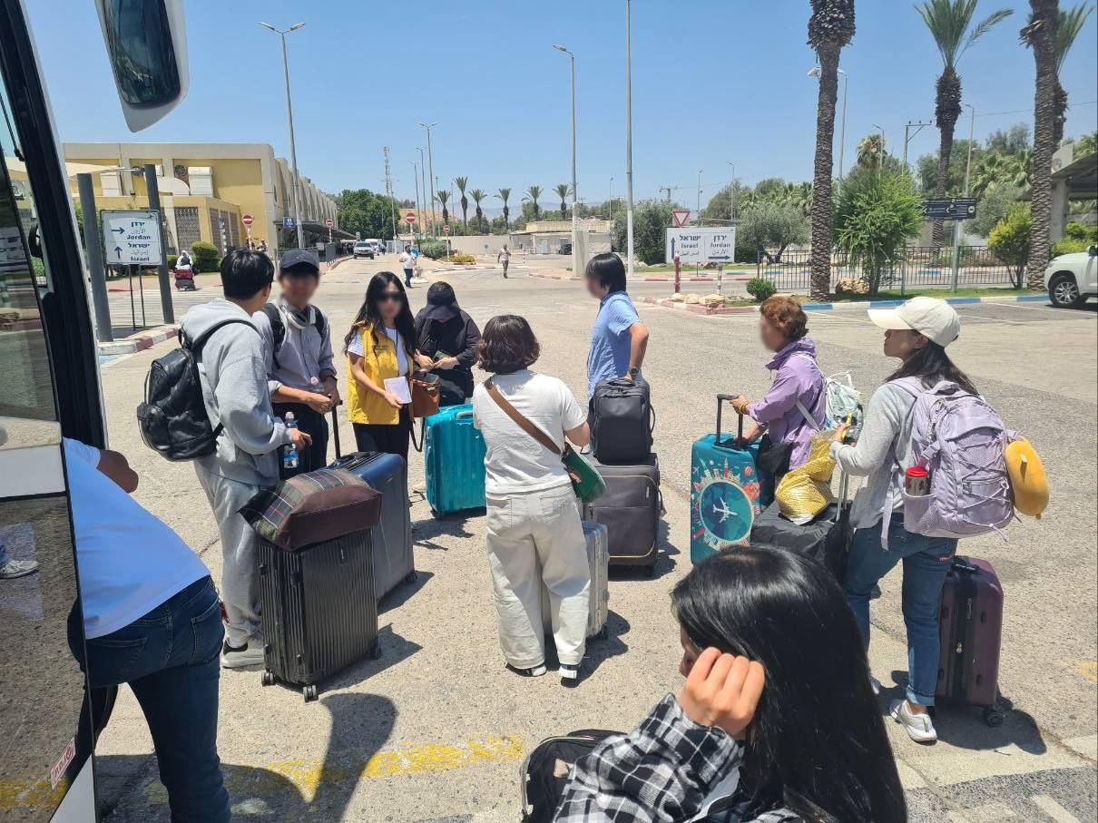 본문 이미지 - 이스라엘 집결지에서 임차 버스를 타기 위해 이동중인 우리 국민들.(외교부 제공)