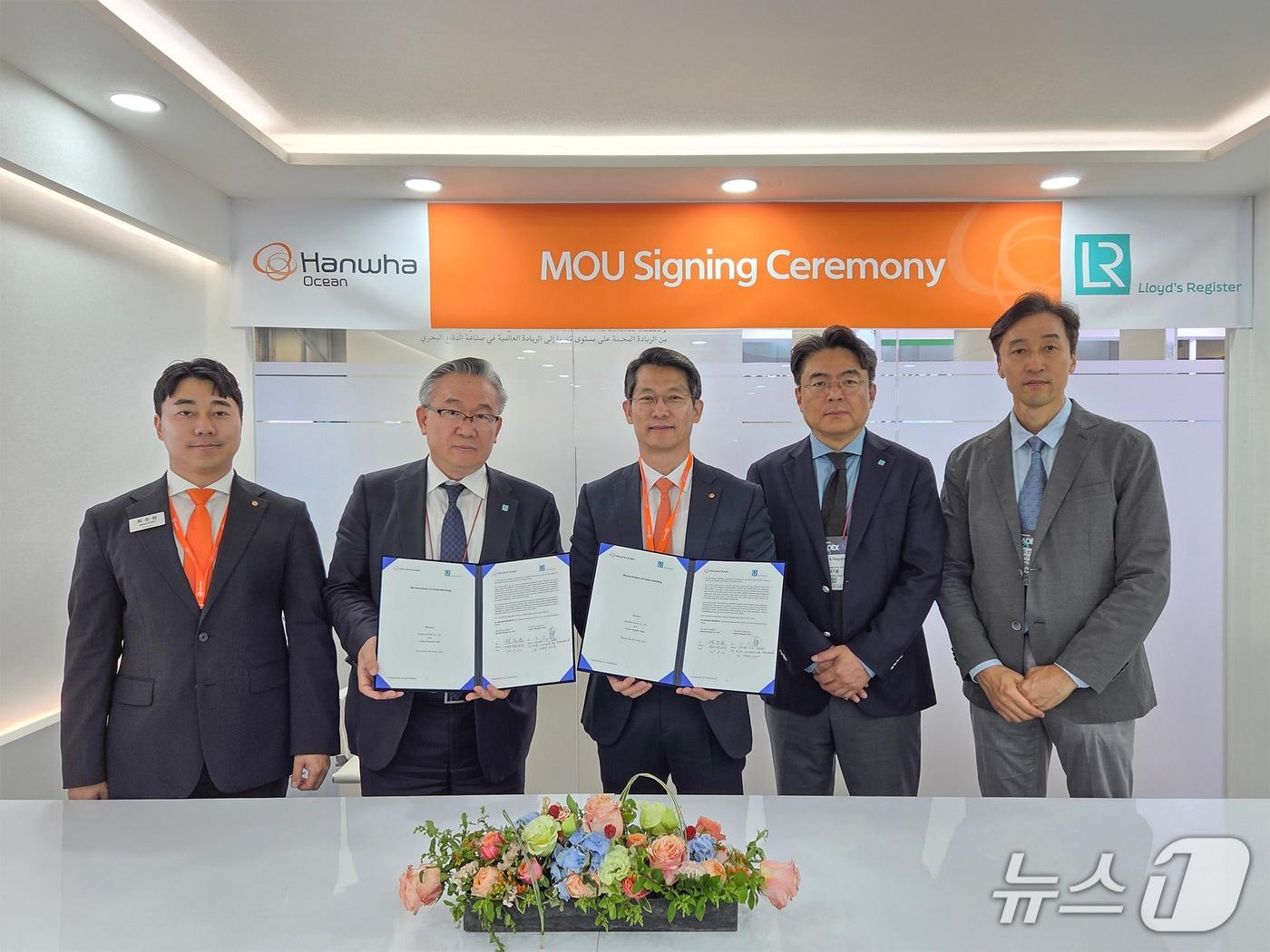 본문 이미지 - 부산 마덱스 현장에서 한화오션과 로이드선급 등 양사 관계자들이 해외 함정수출을 위한 전략적 협력 MOU를 체결한 뒤 기념촬영을 하고 있다.&#40;한화오션 제공&#41;