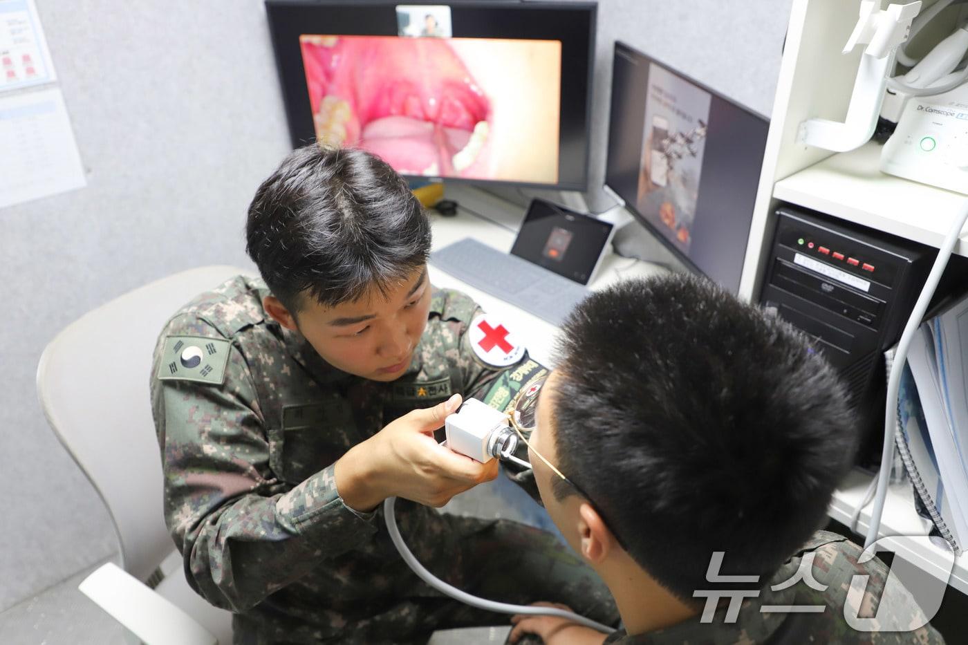 본문 이미지 - '원격진료시스템'을 사용하는 육군 제21사단 GOP대대 소속 의무병이 국군의무사령부 의료종합상황센터 군의관의 화상 지시에 따라 환자 상태를 확인하는 모습. (육군 제공. 재판매 및 DB 금지) 2025.6.20 ⓒ 뉴스1