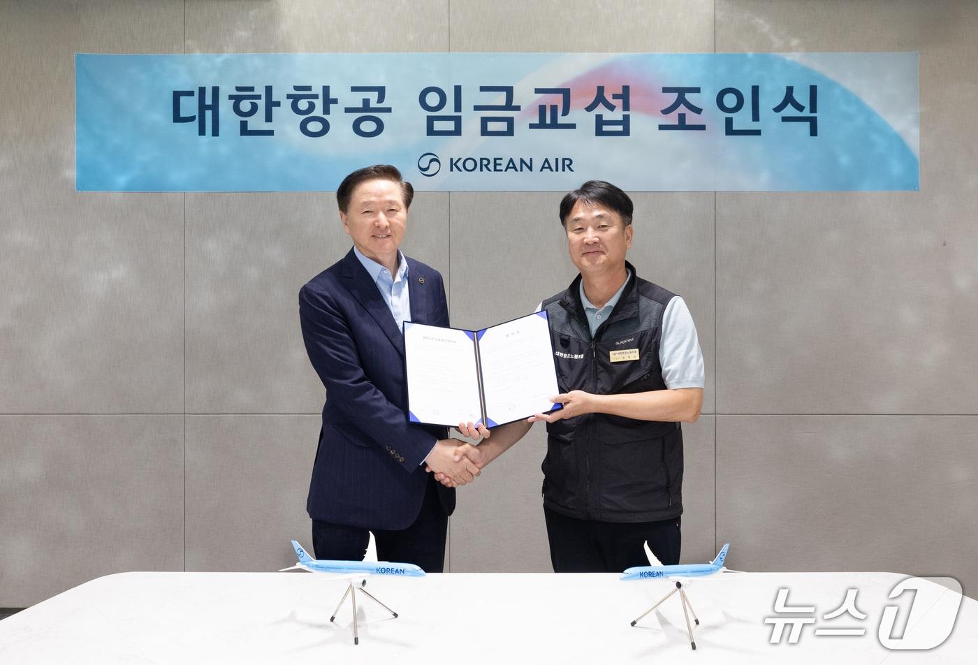 대한항공은 26일 서울 강서구 대한항공 본사에서 ‘2025년 임금교섭 조인식’을 개최했다. 우기홍 대한항공 부회장(왼쪽)과 조영남 대한항공 노동조합위원장(오른쪽)이 기념사진을 촬영하고 있다.(대한항공 제공) 