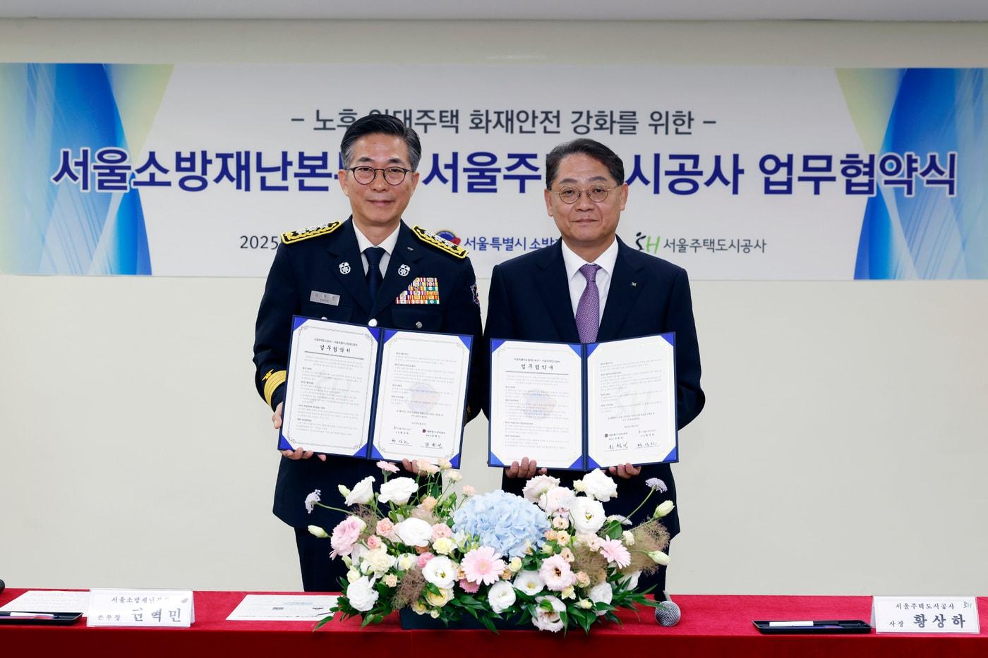 황상하 SH공사 사장&#40;오른쪽&#41;과 권혁민 서울소방재난본부장이 협약 체결 후 협약서를 들어보이고 있다&#40;SH공사 제공&#41;.