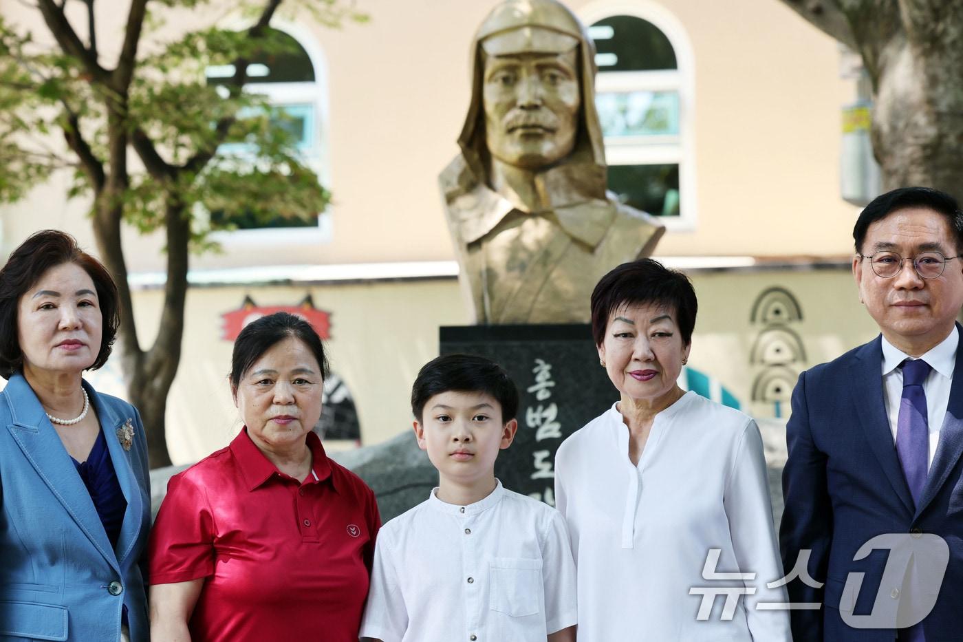 27일 광주 광산구 고려인진료소에서 독립유공자 후손 특별귀화자 3인이 홍범도 장군상 앞에서 기념사진을 찍고 있다. 2025.6.27/뉴스1 ⓒ News1 박지현 기자