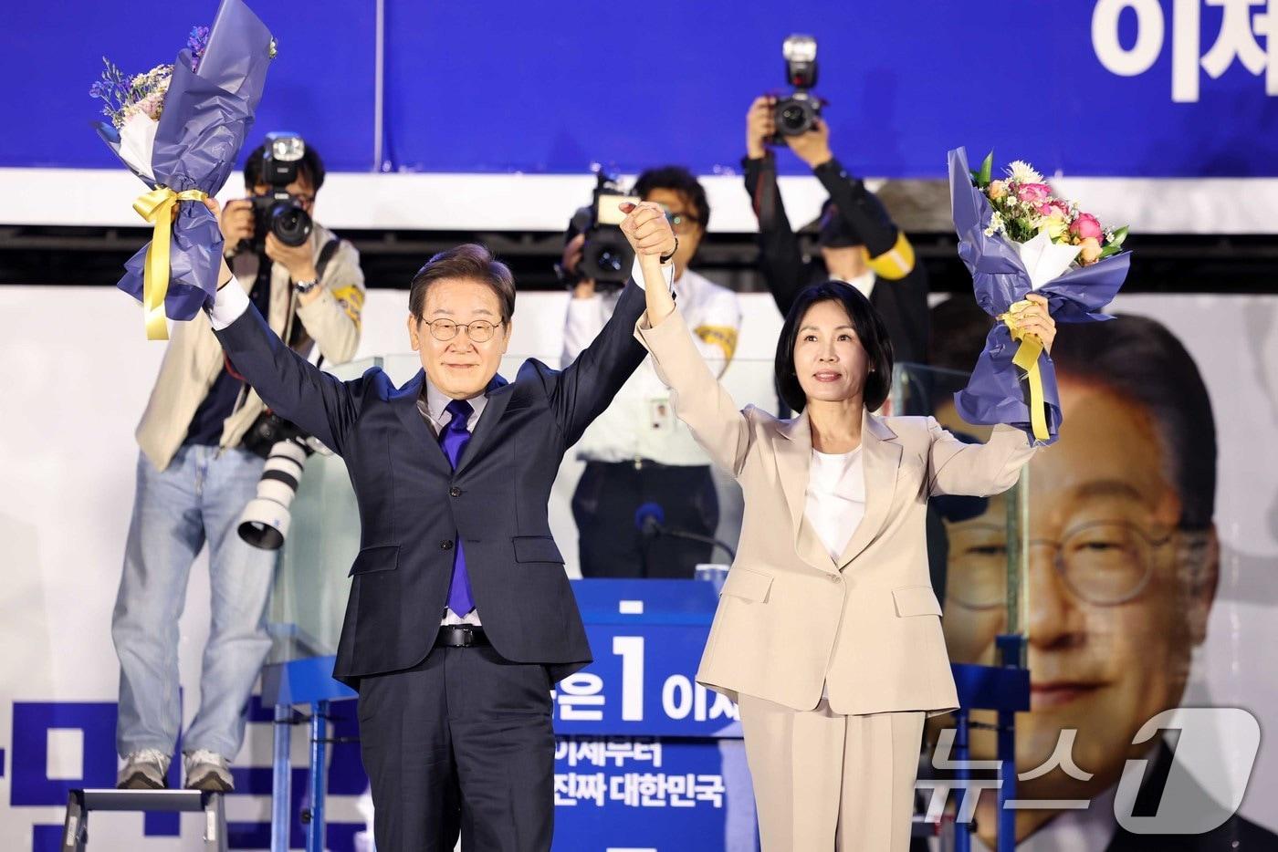 당선이 확실시 되는 이재명 더불어민주당 대선후보와 김혜경 여사가 4일 오전 서울 여의도 국회 앞에서 열린 국민 개표방송 행사에서 꽃다발을 받은 뒤 시민들을 향해 인사하고 있다. &#40;공동취재&#41; 2025.6.4/뉴스1 ⓒ News1 안은나 기자