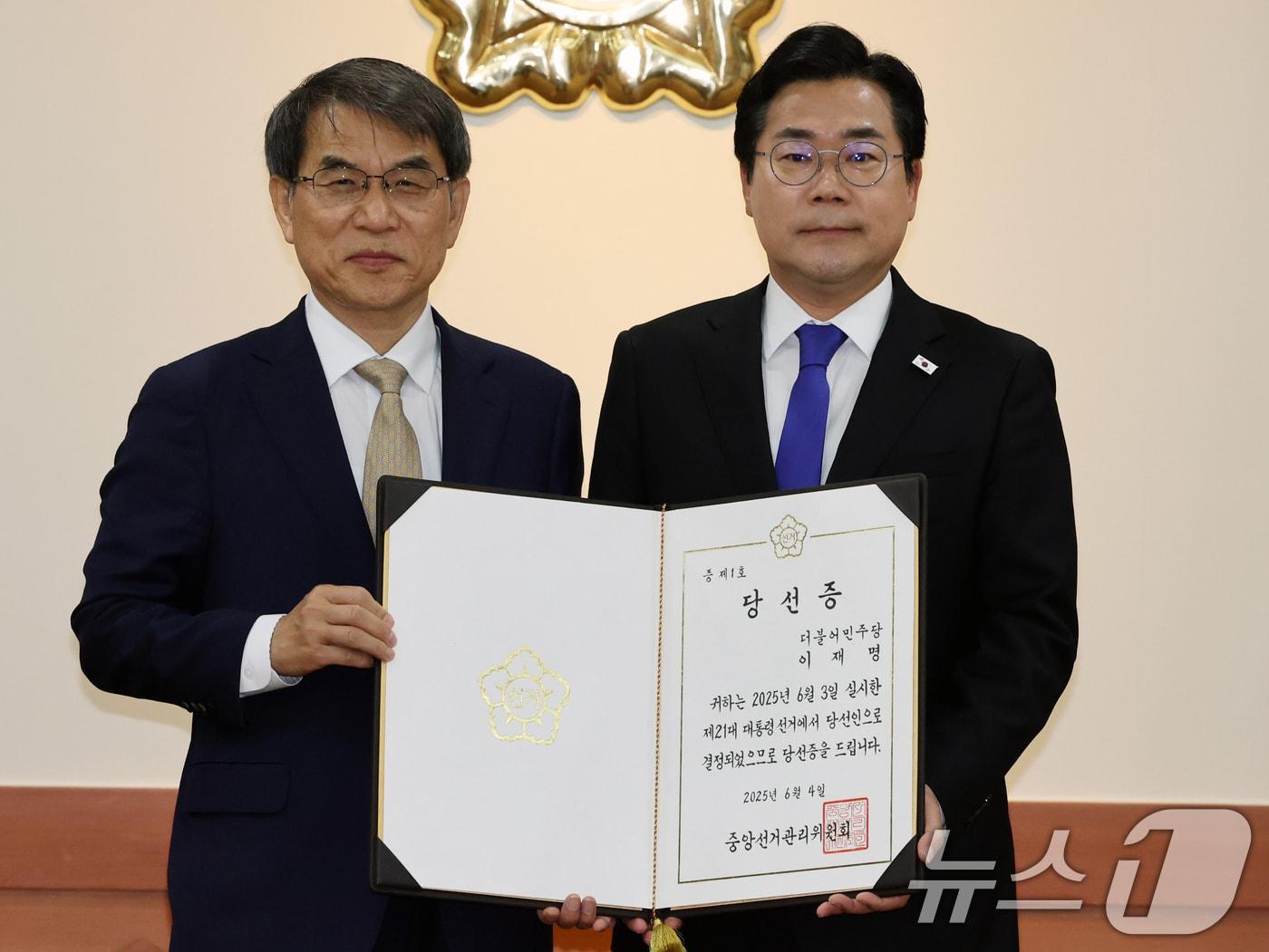 본문 이미지 - 노태악 중앙선거관리위원장(왼쪽)이 4일 오전 경기 과천시 중앙선관위에서 박찬대 더불어민주당 원내대표에게 이재명 대통령 당선증을 수여하고 있다. 2025.6.4/뉴스1 ⓒ News1 황기선 기자