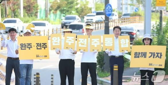 본문 이미지 - 우범기 시장이 23일 이른 아침 덕진구 사랑의울타리 봉사단과 함께 호남제일문 사거리에서 출근길 통합 캠페인을 전개하고 있다.(전주시 제공, 재판매 및 DB 금지)/뉴스1