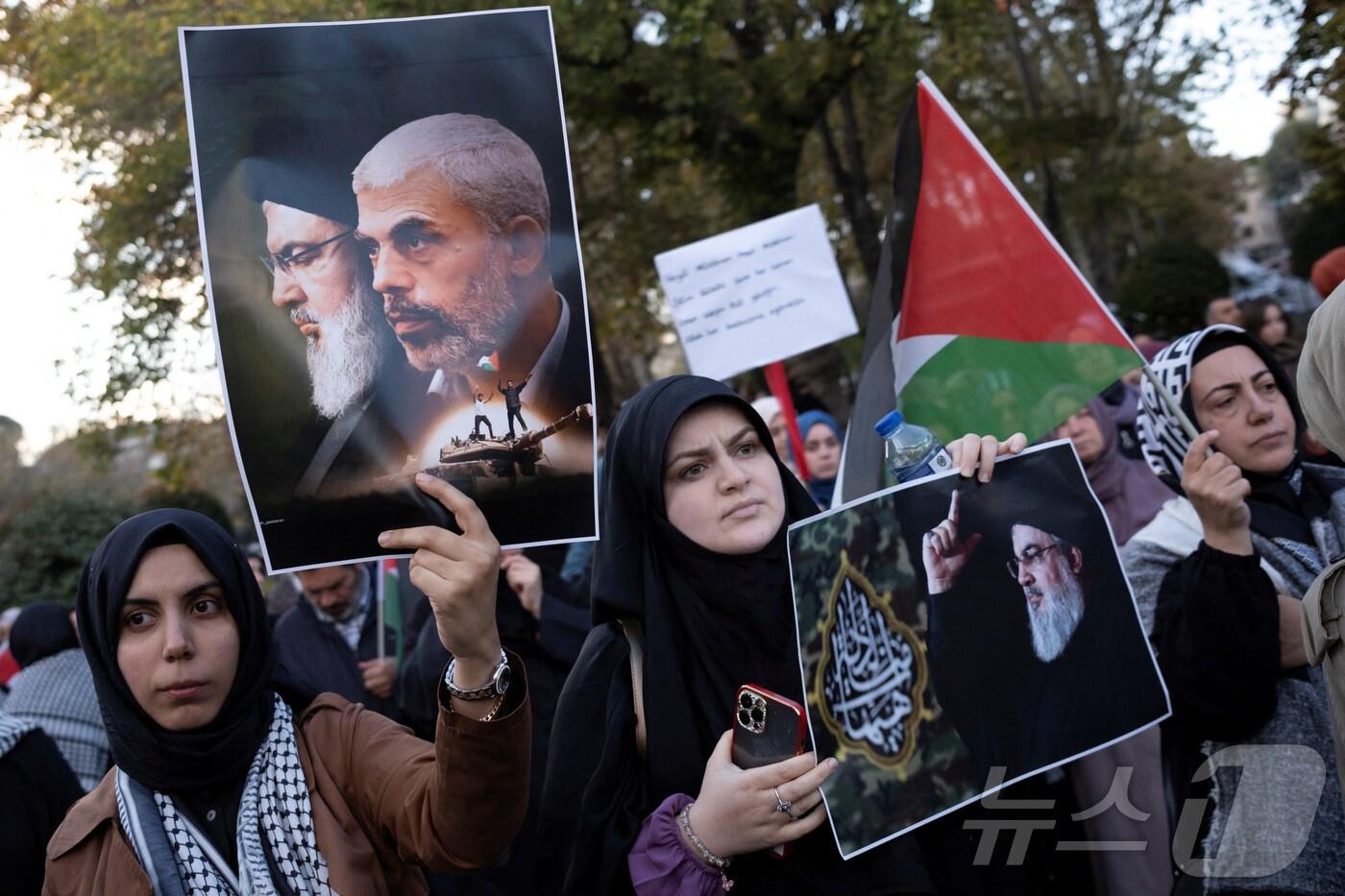 2024년 10월 20일 튀르키예 이스탄불에서 팔레스타인 지지 시위대가 전 하마스 지도자 야흐야 신와르 암살을 규탄하는 시위에 참여해 사이예드 하산 나사랄라 헤즈볼라 사무총장과 야흐야 신와르의 사진을 들고 있는 모습. 2024.10.20. ⓒ 로이터=뉴스1 ⓒ News1 윤다정 기자