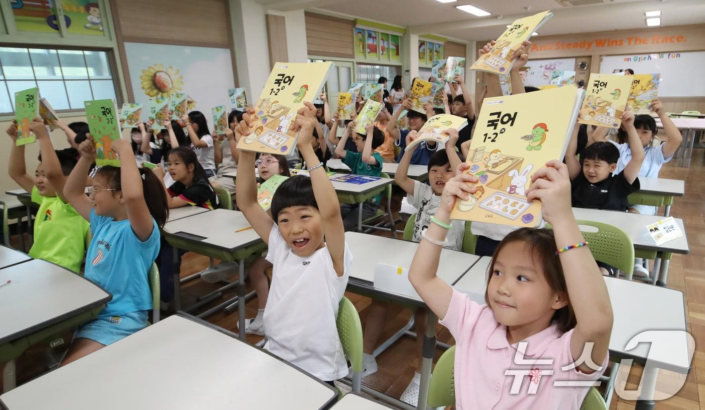 여름방학을 마치고 개학한 부산 사상구 모동초등학교에서 학생들이 새학기 교과서를 들어 보이고 있다. 2025.8.11/뉴스1 ⓒ News1 윤일지 기자
