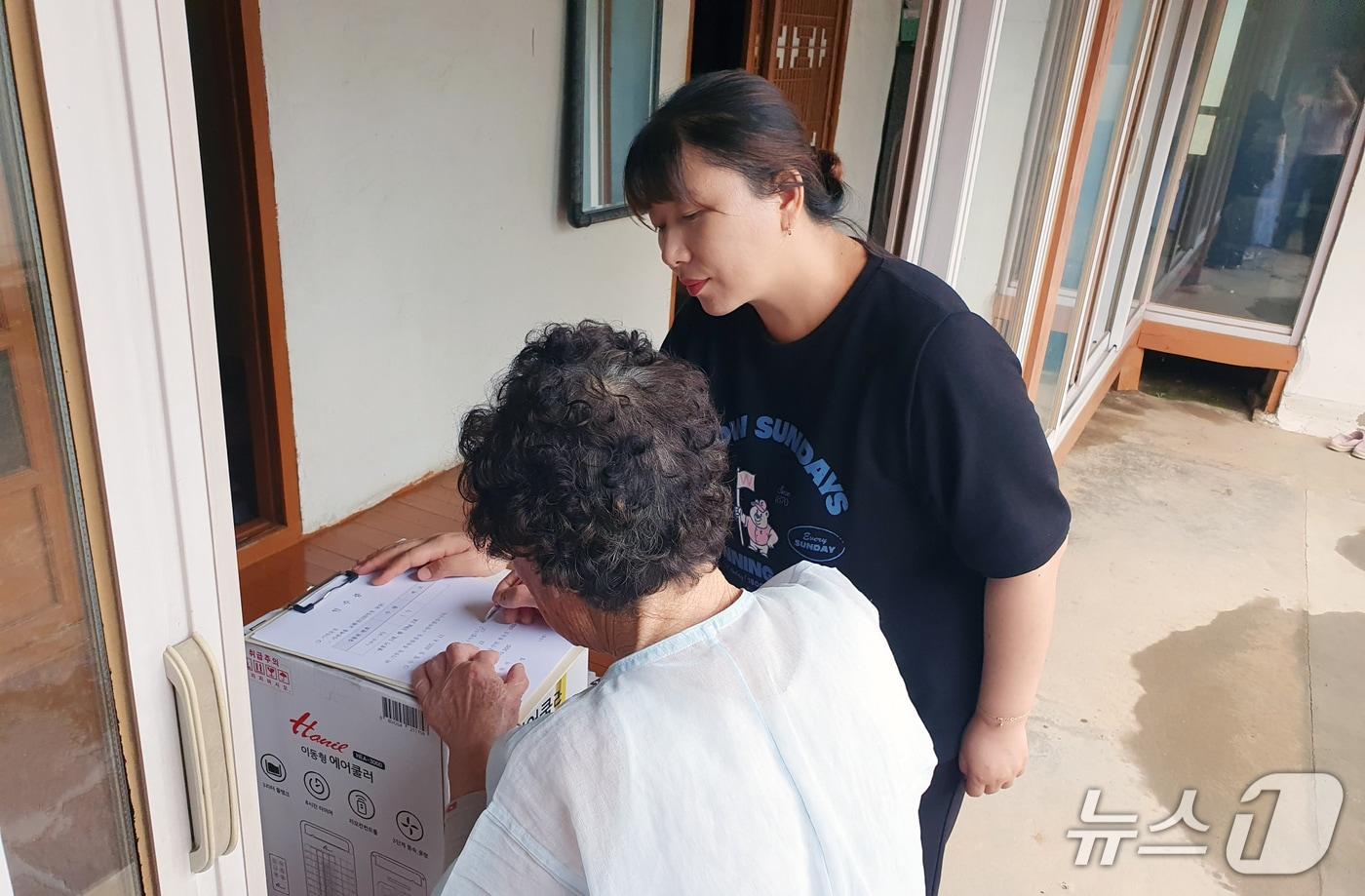 서산시가 집중호우 피해를 본 가구에 온정으로 전달된 전자제품 교환권 등을 전달하는 모습(서산시 제공. 재판매 및 DB금지)2025.8.12/뉴스1