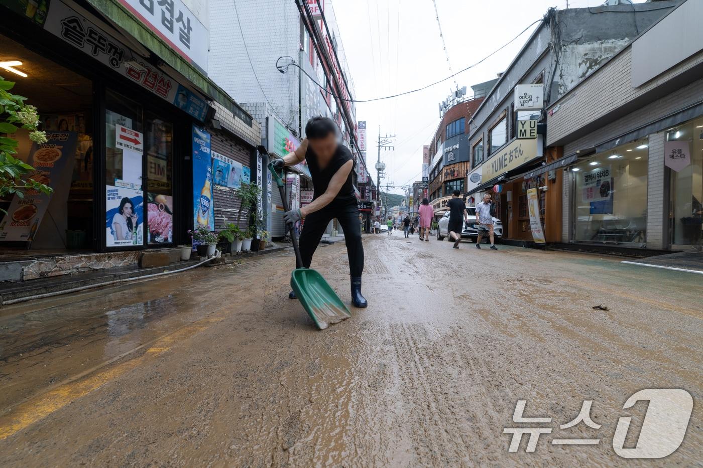 13일 오후 서울 은평구 연신내역 인근 상가 거리에서 상인들이 폭우로 인해 더러워진 거리를 청소하고 있다. 2025.8.13/뉴스1 ⓒ News1 이승배 기자