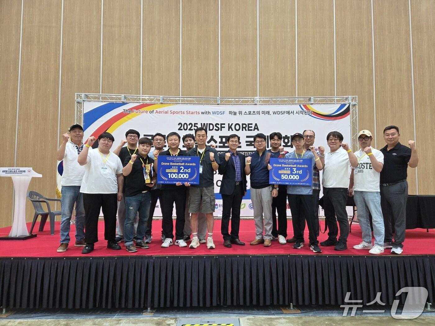 본문 이미지 - 신성대 드론자동차모빌리티과 재학생들이 청주에서 열린 ‘2025 글로벌 드론스포츠 국제대회’에 참가해 2위와 3위를 수상을 축하하며 기념촬영을 하고 있다.(신성대 제공. 재판매 및 DB금지)2025.8.13/뉴스1