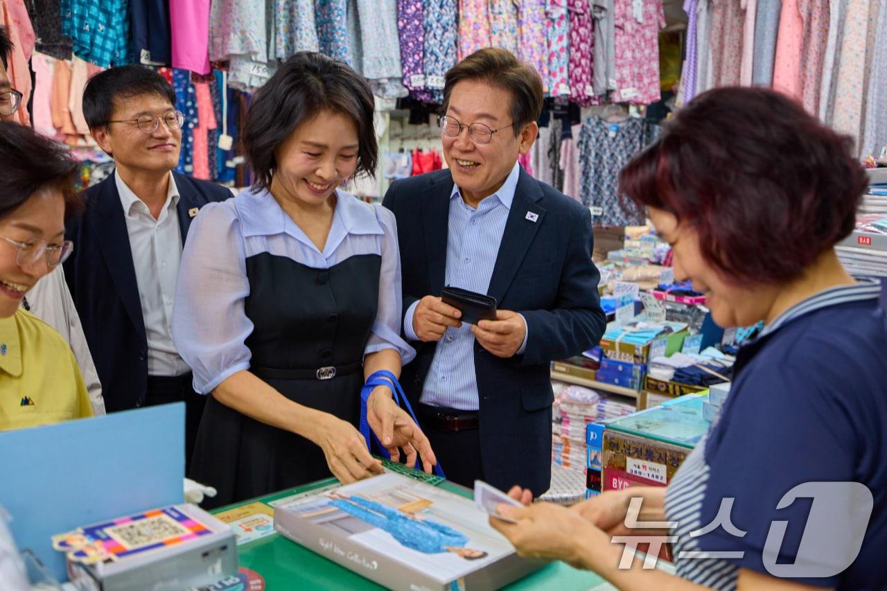 본문 이미지 - 이재명 대통령과 김혜경 여사가 17일 서울 은평구 연서시장을 방문해 상품을 고르고 있다. &#40;이재명 대통령 SNS. 재판매 및 DB 금지&#41; 2025.8.17/뉴스1 ⓒ News1 허경 기자