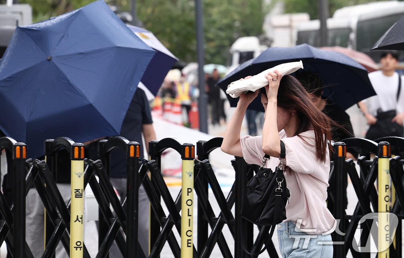 비가 내린 25일 오전 서울 종로구 광화문 일대에서 우산을 준비하지 못한 시민들이 가방으로 비를 막은 채 출근길 발걸음을 서두르고 있다. 2025.8.25/뉴스1 ⓒ News1 김성진 기자