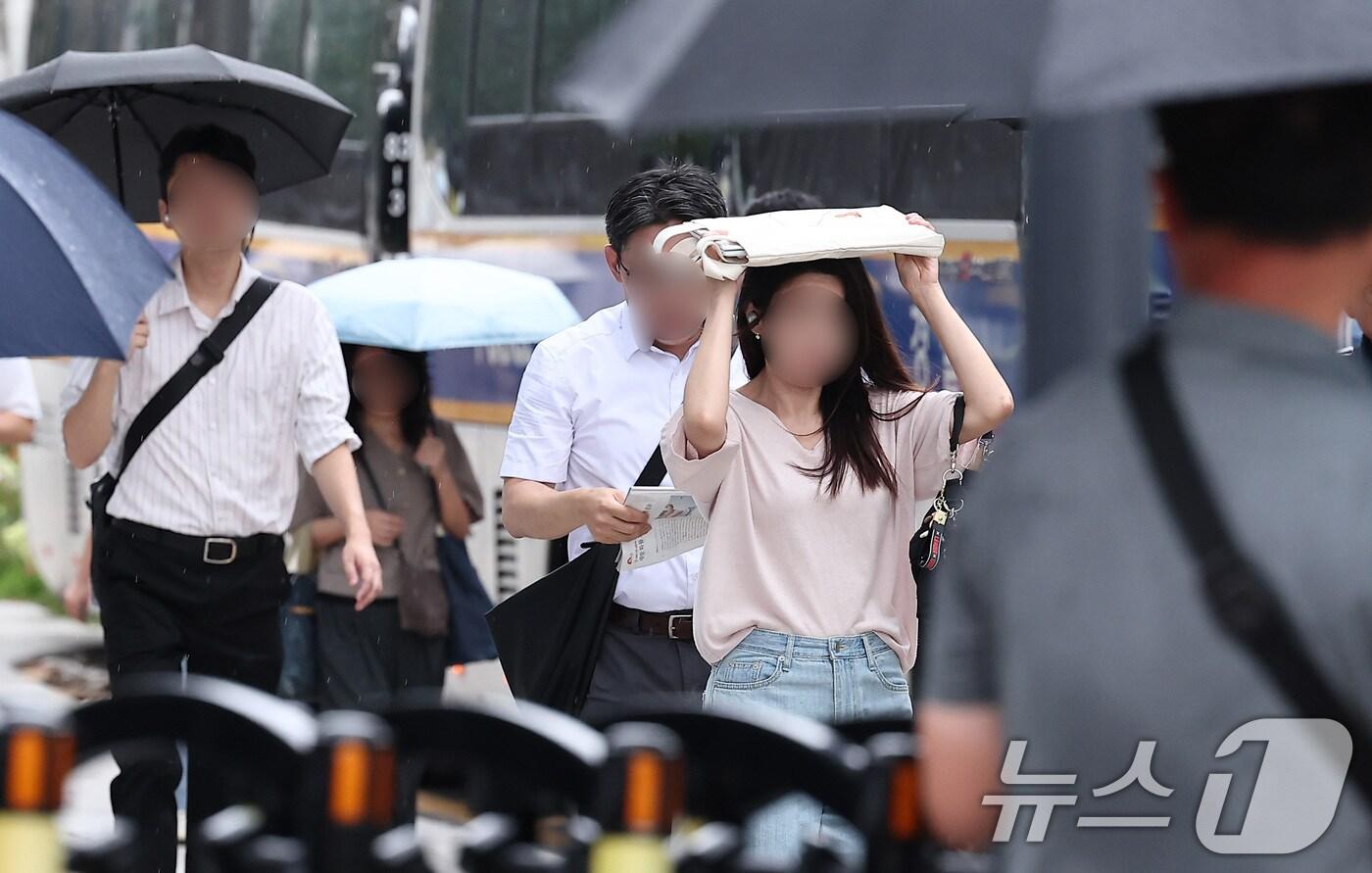 비가 내린 25일 오전 서울 종로구 광화문 일대에서 우산을 준비하지 못한 시민이 가방으로 비를 막은 채 출근길 발걸음을 서두르고 있다. 2025.8.25/뉴스1 ⓒ News1 김성진 기자
