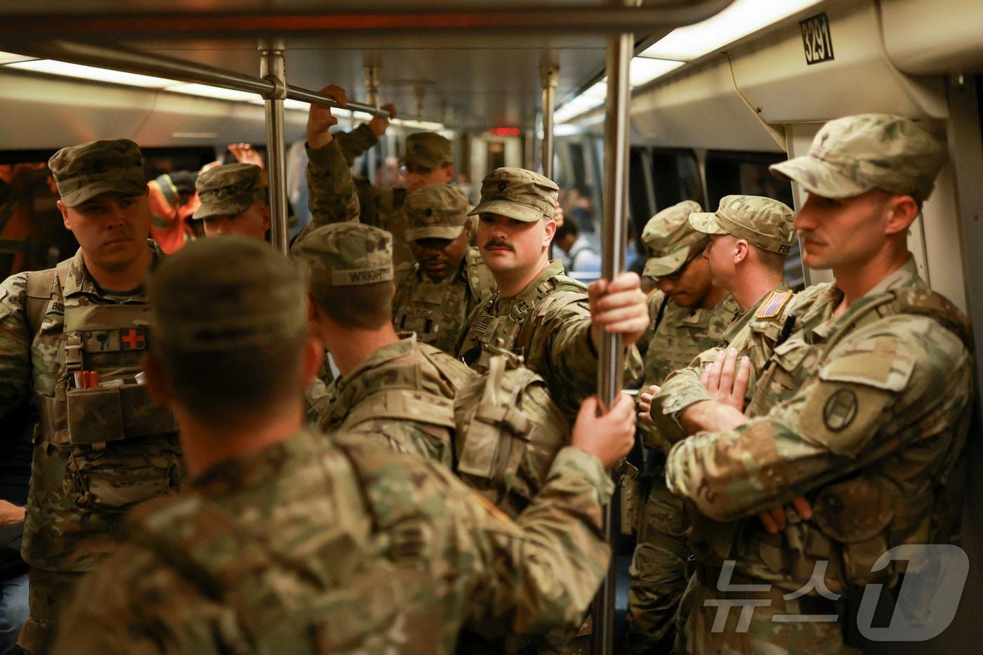본문 이미지 - 미국 워싱턴 DC에서 도널드 트럼프 대통령이 치안 유지를 위해 투입한 사우스캐롤라이나주 방위군 병사들이 지하철에 탑승한 모습. 2025.08.26 ⓒ 로이터=뉴스1