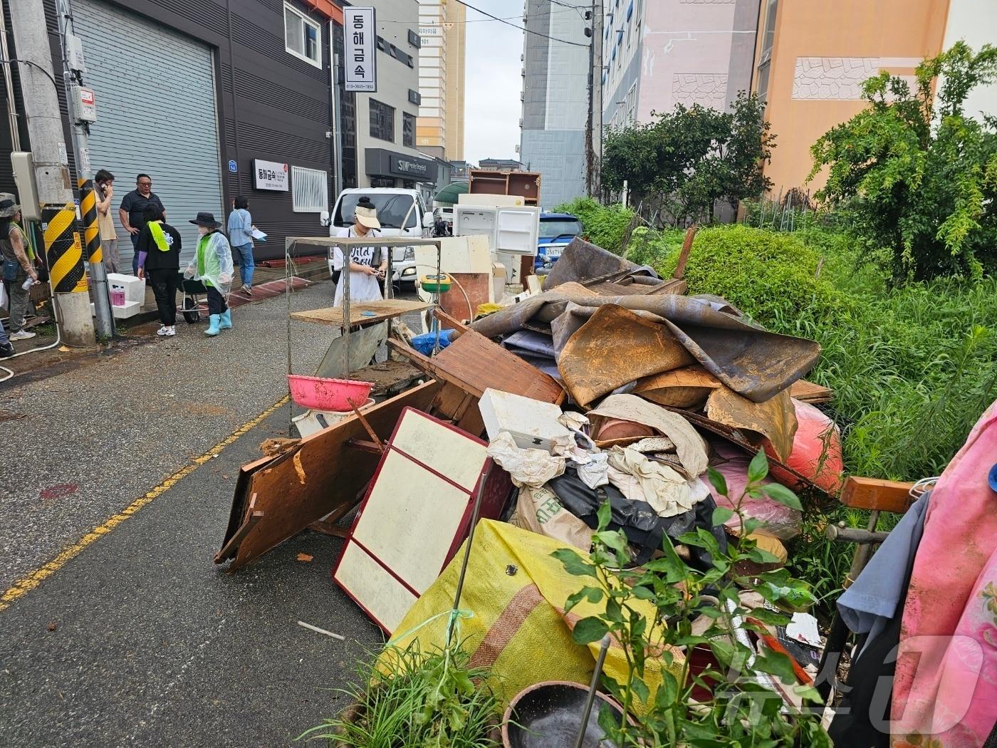 본문 이미지 - 자원봉사자들이 4일 광주 북구 신안동 서방천 인근 마을의 침수 주택에서 물에 잠긴 가재도구들을 꺼내고 있다. 2025.8.4/뉴스1 ⓒ News1 최성국 기자