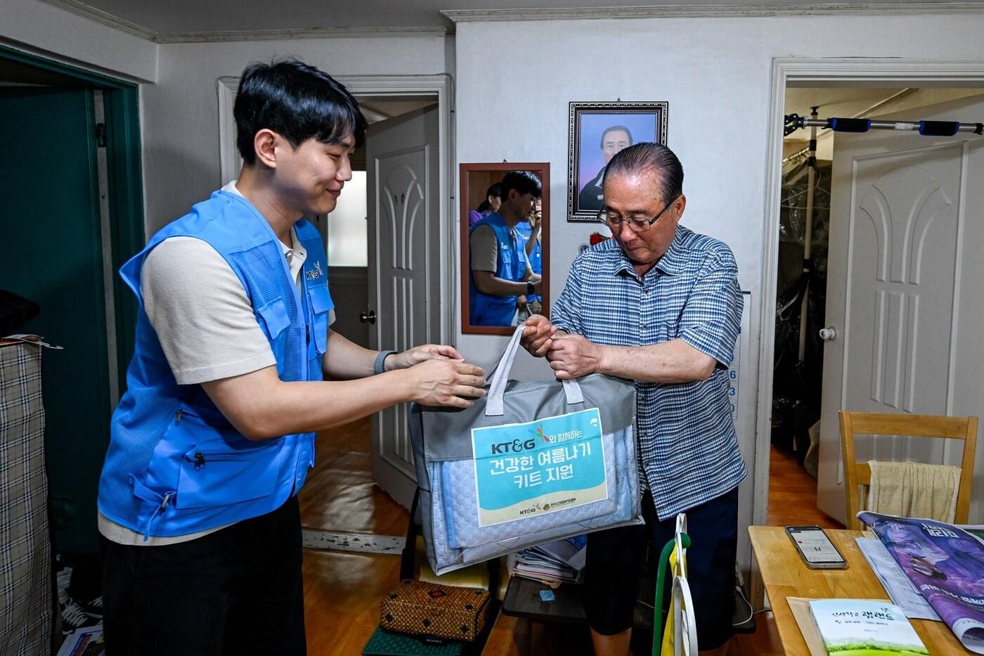 KT&G가 폭염 피해 취약계층을 위해 여름나기 물품을 지난 5일 긴급 지원했다. 사진은 봉사활동에 참여한 직원이 여름나기 물품을 전달하는 모습&#40;KT&G 제공&#41;