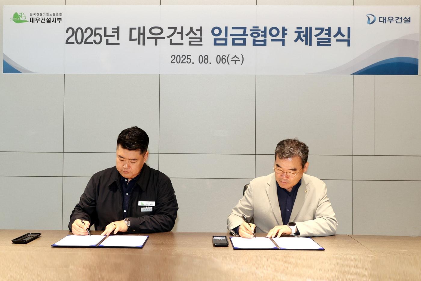 대우건설 2025년 임금협약 체결식에서 김보현 사장(오른쪽)과 심상철 대우건설 노동조합위원장이 서명하고 있다.(대우건설 제공)