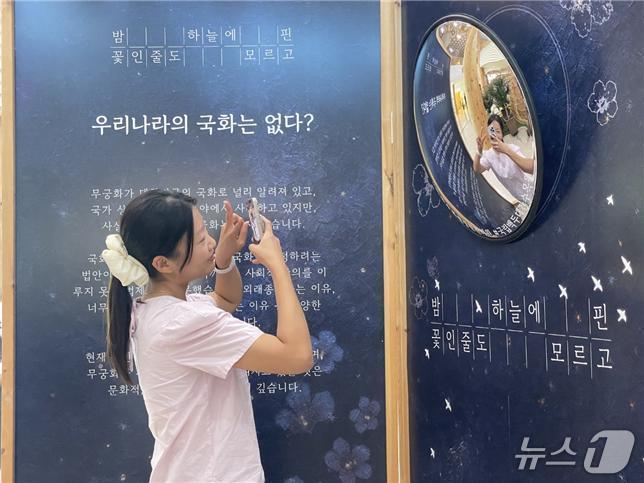 본문 이미지 -  국립백두대간수목원을 찾은 관람객이 방문자센터에 조성된 무궁화 전시물 앞에서 사진을 찍고 있다. (한국수목원정원관리원 제공.재판매 및 DB금지) /뉴스1