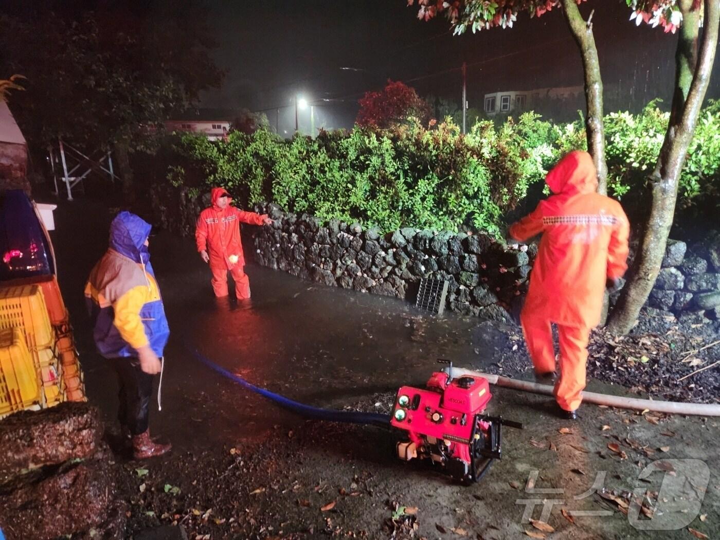 본문 이미지 - 12일 오전 4시7분쯤 제주 서귀포시 남원읍 의귀리 소재 주택과 마당이 빗물에 잠겨 소방당국이 배수지원을 하고 있다.&#40;제주도소방안전본부 제공. 재판매 및 DB 금지&#41; /뉴스1