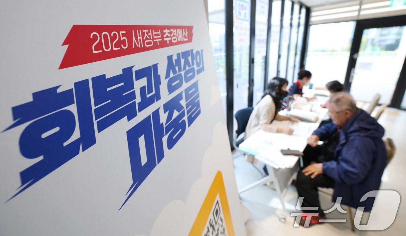 전 국민의 90%에게 10만원씩 지급하는 &#39;민생회복 소비쿠폰&#39;의 2차 신청 첫날인 22일 경기 수원시 팔달구 고등동행정복지센터에서 시민들이 소비쿠폰 신청을 하고 있다. 2025.9.22/뉴스1 ⓒ News1 김영운 기자