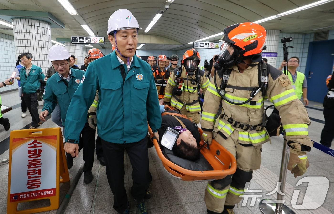 오세훈 서울시장이 서울 영등포구 여의나루역 일대에서 열린 &#39;2025년 서울시 재난대응 안전한국훈련&#39;에서 소방대원들과 함께 인명 구조 훈련을 하고 있다.  2025.9.22/뉴스1 ⓒ News1 허경 기자
