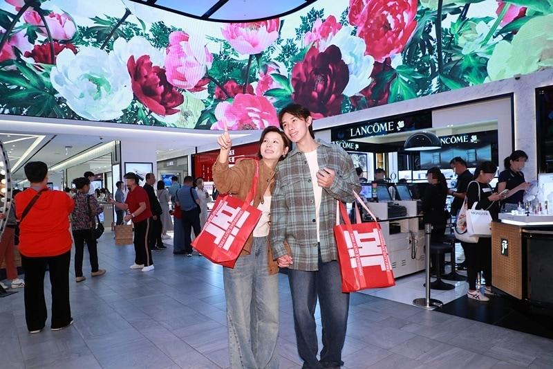 본문 이미지 - 신세계면세점 명동점 10층 아이코닉존 미디어파사드를 감상하는 중국인 고객들(신세계면세점 제공)