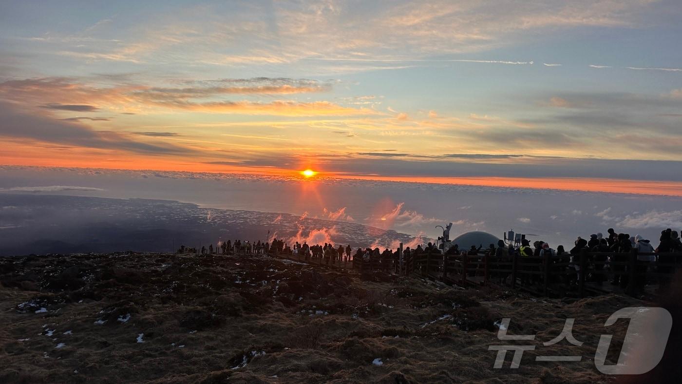 2026년 새해 첫날인 1일 제주 한라산 정상인 백록담에 오른 탐방객들이 구름 사이로 뜨는 해를 바라보고 있다.(한라산국립공원관리소 제공. 재판매 및 DB 금지). 2026.1.1/뉴스1 ⓒ News1 강승남 기자