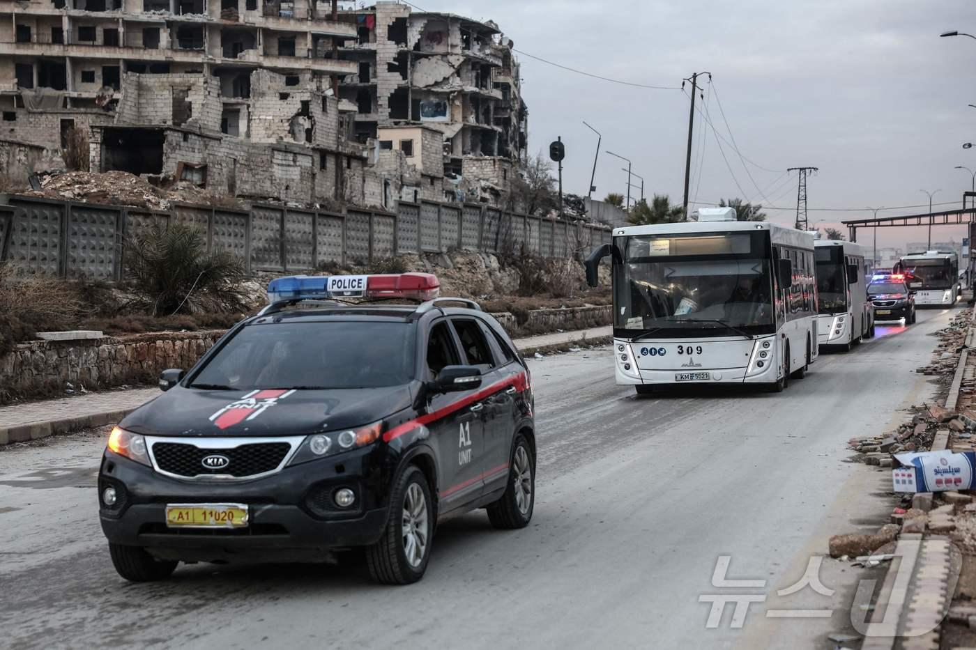 10일(현지시간) 시리아 북서부 알레포에서 쿠르드족 시리아 민주군(SDF)의 전투원을 태운 버스와 호송 차량이 시리아 북동부 지역으로 출발하는 모습. 2026.01.10 ⓒ AFP=뉴스1 ⓒ News1 김지완 기자