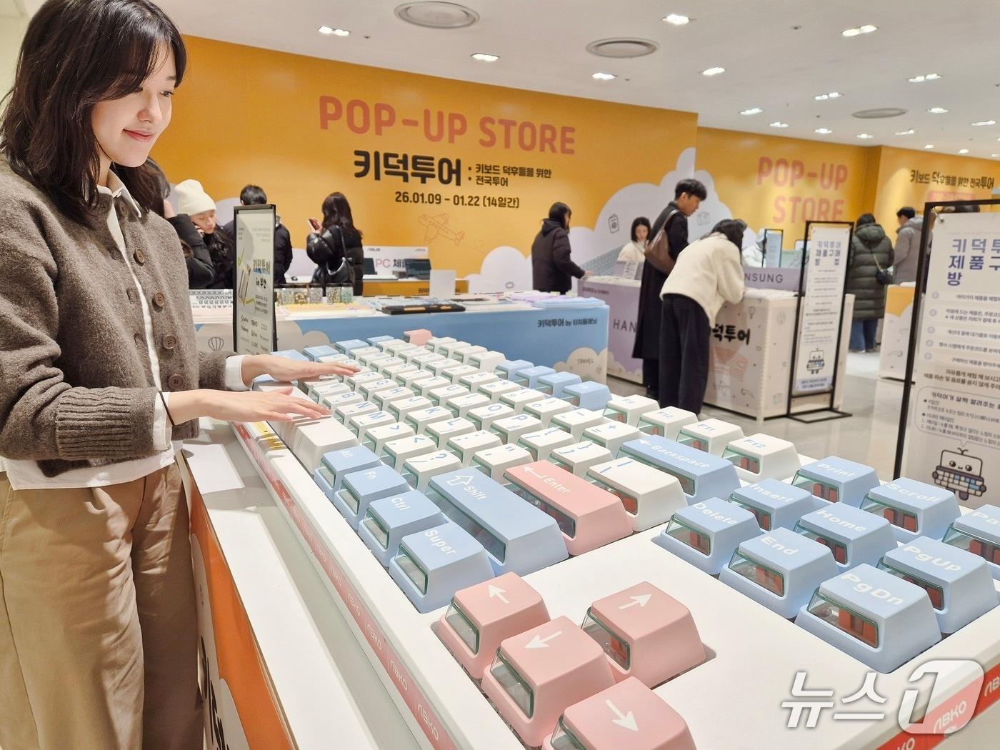 본문 이미지 - 롯데백화점 부산본점 키덕투어 인 부산 팝업 매장을 방문한 고객이  대형 키보드를 두드려 보고 있다.(롯데백화점 부산본점 제공. 재판매 및 DB 금지)