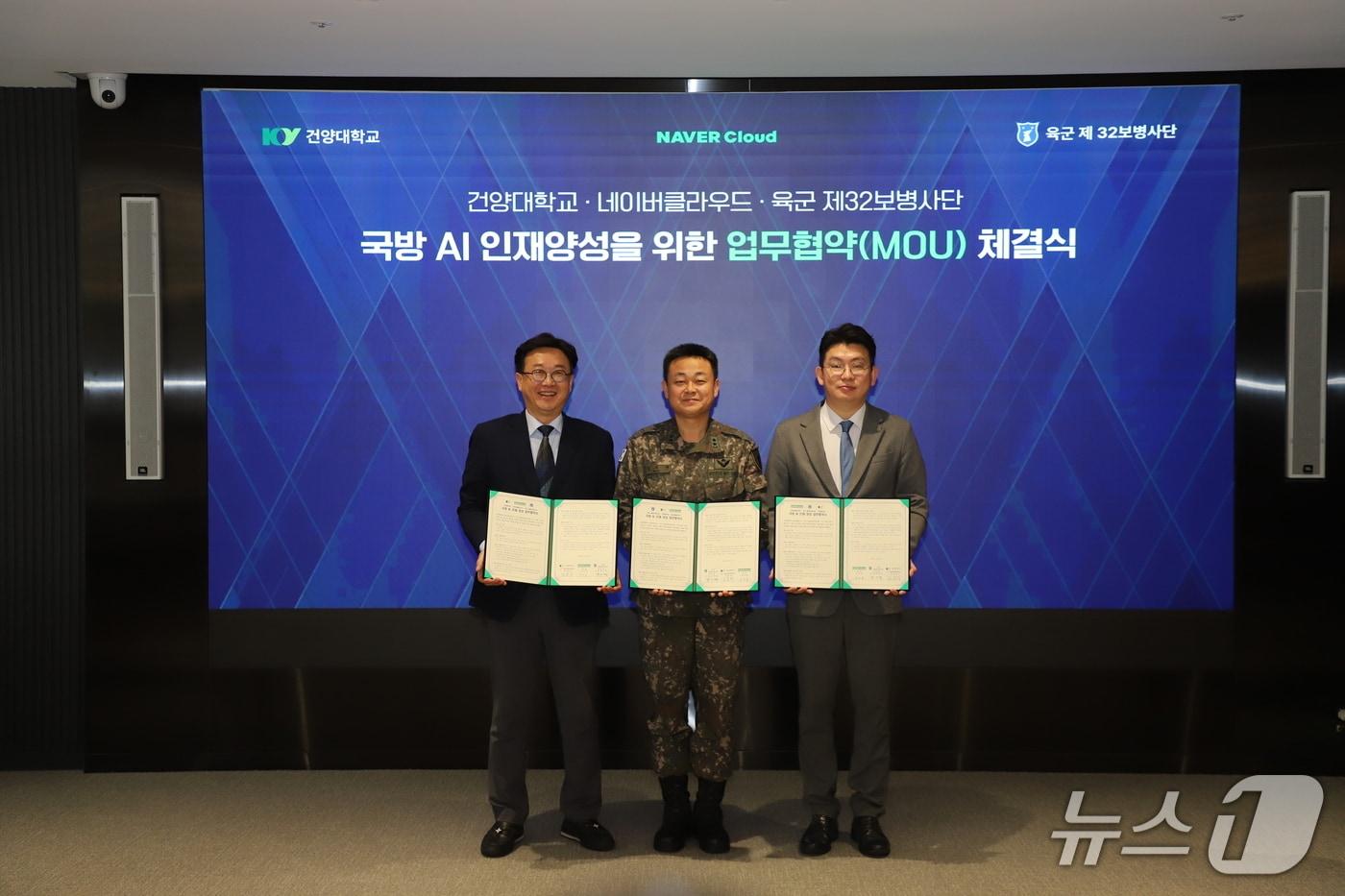 본문 이미지 - 김용석 건양대학교 AI·SW융합대학장(왼쪽)과 김지면 32보병사단장(가운데), 김한결 네이버클라우드 상무가 19일 인공지능 역량강화 및 인재양성을 위한 업무협약을 체결하고 협약서를 들어보이고 있다.(32사단 제공) /뉴스1