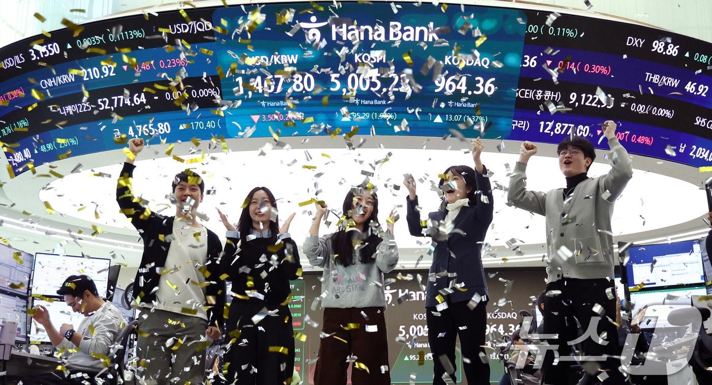 본문 이미지 - 22일 오전 서울 중구 하나은행 본점 딜링룸 현황판에 코스피 지수가 장중 5000p를 넘으며 개장하자 직원들이 환호하고 있다. 2026.1.22/뉴스1 ⓒ News1 박지혜 기자