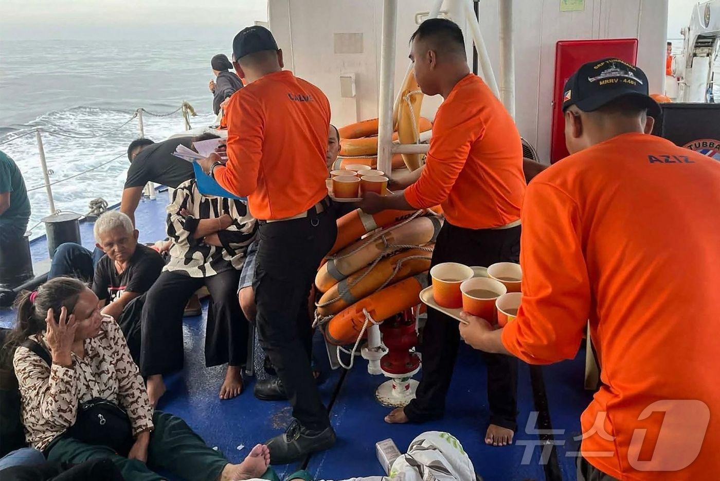 본문 이미지 - 26일(현지시간) 필리핀 해안경비대원들이 바실란주 인근 해역에서 침몰한 여객선 M/V 트리샤 커스틴 3호 구조자들을 보살피고 있다. 2026.01.26. ⓒ AFP=뉴스1 ⓒ News1 윤다정 기자