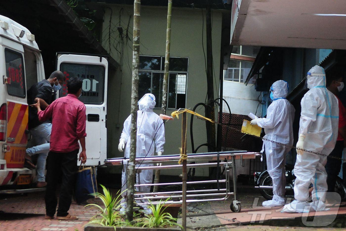 본문 이미지 - 2023년 9월 14일 인도 케랄라주 코지코데의 한 정부 병원에서 방호복을 착용한 의료진이 니파 바이러스 감염자와 접촉한 사람들을 격리 시설로 이송하고 있다.2023.09.14. ⓒ AFP=뉴스1