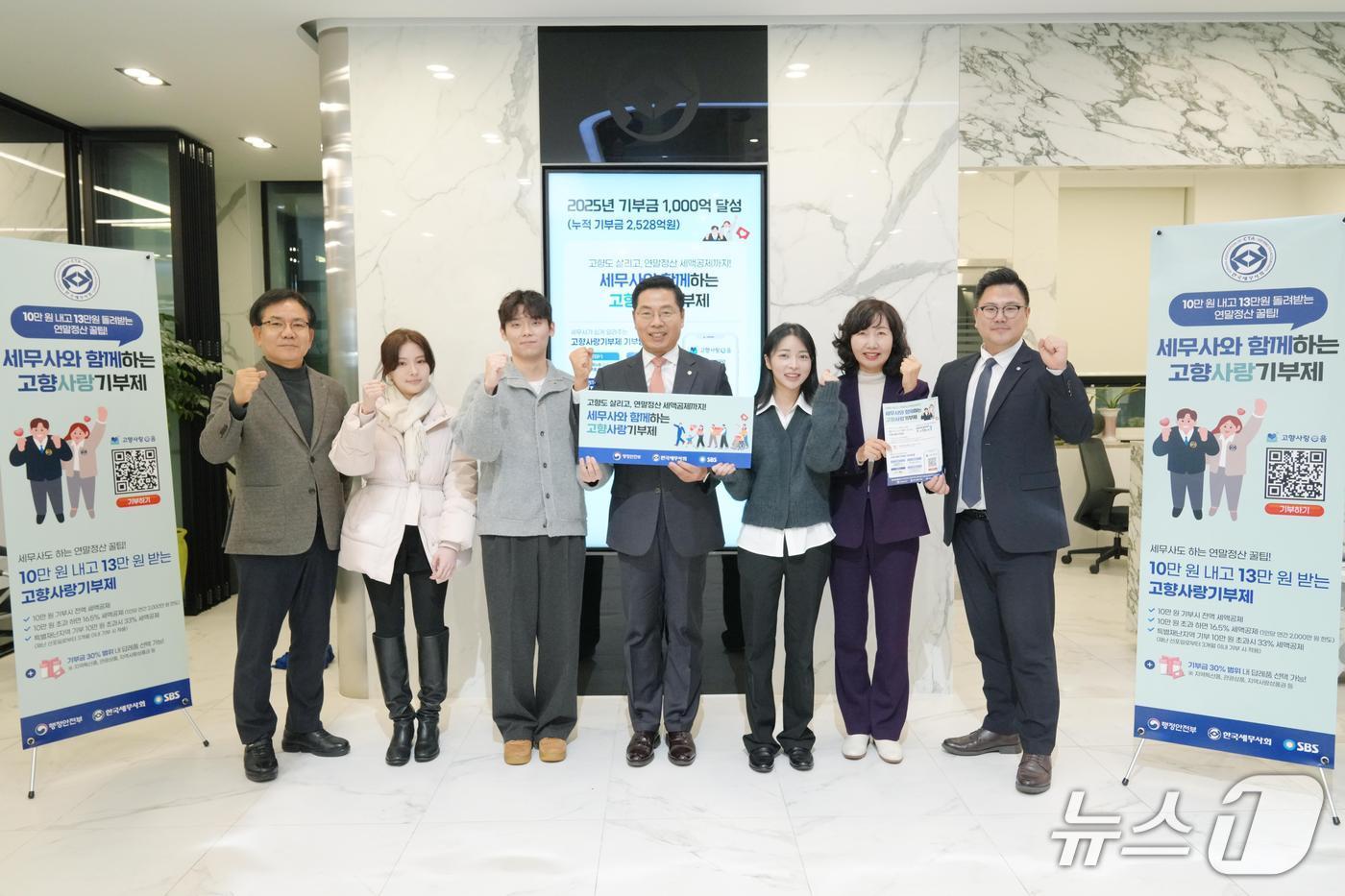 전국 1만7000명 세무사의 현장 중심 지원 활동에 힘입어 '고향사랑기부제'의 지난해 모금액이 제도 시행 이후 최대를 기록했다. 지난해 12월 16일 구재이 한국세무사회 회장(가운데)과 직원들이 누적 1000억 원 돌파를 축하하고 있는 모습.(한국세무사회 제공. 재판매 및 DB금지)/뉴스1