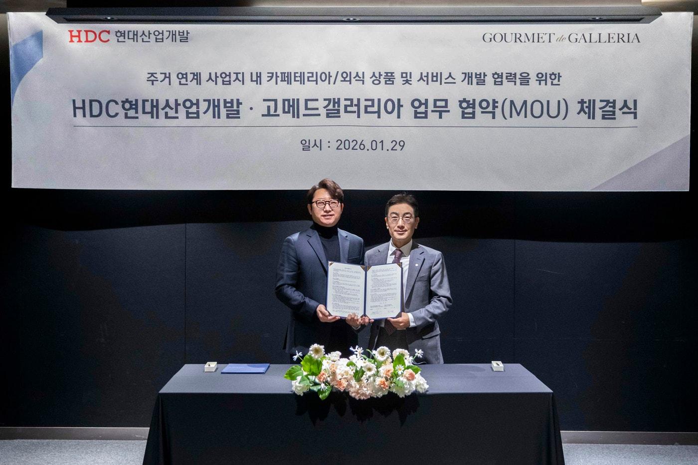 본문 이미지 - 29일 코엑스 아셈볼룸에서 진행된 ‘주거 연계 F&B 서비스’ 업무협약식에서 차기팔 고메드갤러리아 대표이사와 배치성 HDC현대산업개발 영업본부장이 기념사진을 촬영하고 있다.(아워홈 제공)