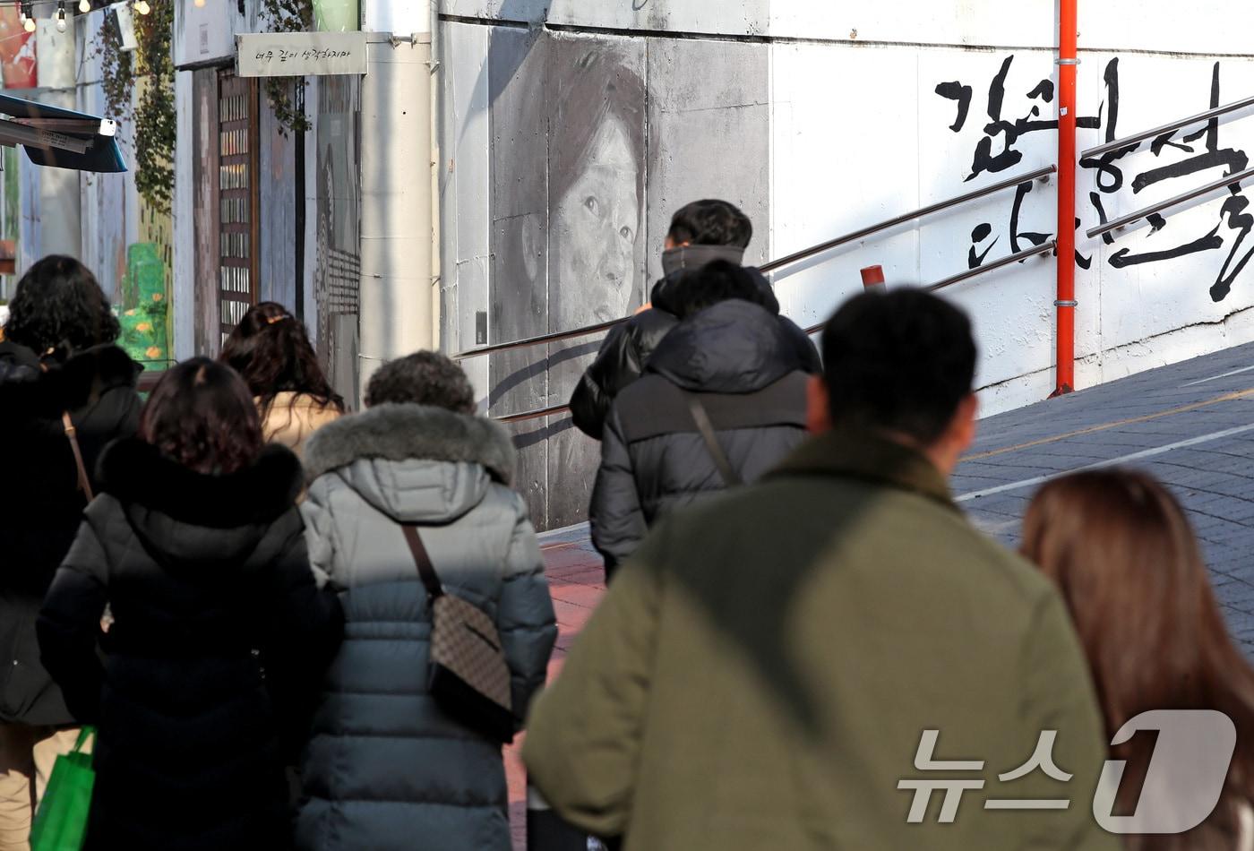 한파가 물러가고 포근한 날씨를 보인 4일 오후 '영원한 가객' 故 김광석(1964~1996) 30주기를 이틀 앞두고 주말을 맞아 대구 중구 방천시장 김광석길을 찾은 시민들이 김광석의 노래를 들으며 그를 추억하고 있다. 김광석이 태어나고 세상을 떠난 날이 모두 1월이어서 이맘때면 김광석길을 찾는 발길이 늘어난다. 30주기인 6일 김광석길에서는 다양한 추모 행사가 열린다. 2026.1.4/뉴스1 ⓒ News1 공정식 기자