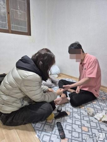 본문 이미지 - 장위1동 방문간호사가 이씨의 집을 방문해 건강상태를 확인하고 있다.(성북구 제공)