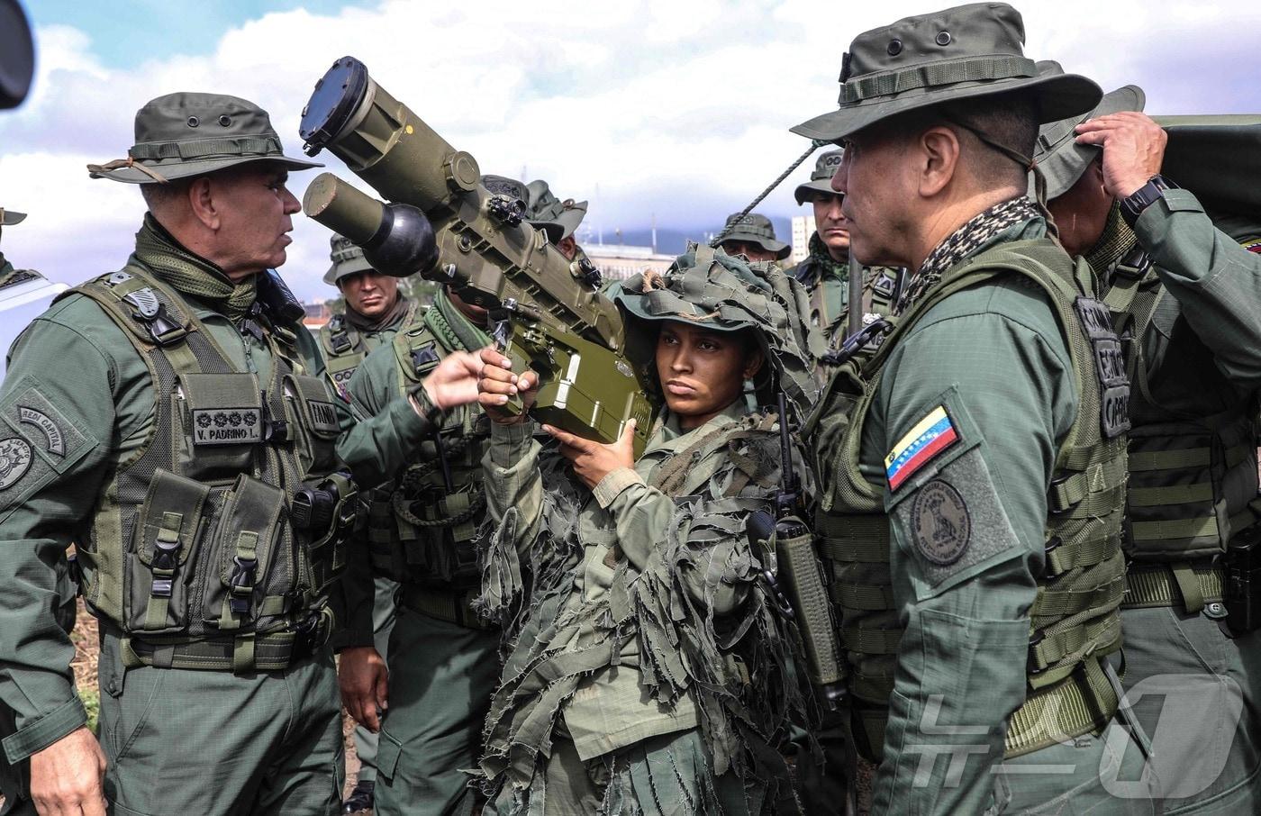 베네수엘라 국방부가 공개한 이 사진은 2025년 11월 11일 카라카스에서 실시된 훈련 중 블라디미르 파드리노 로페스 베네수엘라 국방부 장관(오른쪽)이 이글라-S를 들고 있는 병사를 관찰하는 모습을 담고 있다. 2025.11.11. ⓒ AFP=뉴스1 ⓒ News1 이정환 기자