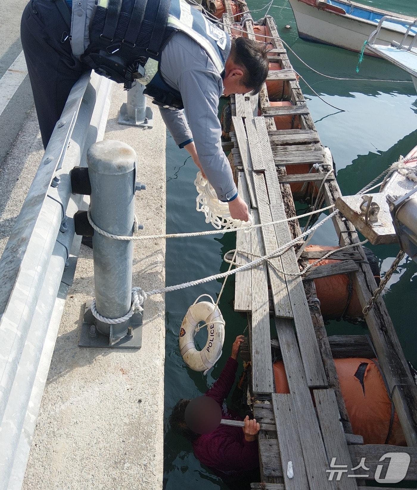 본문 이미지 - 지난 7일 오전 11시 25분쯤 완도군 금일도 폐부잔교 인근에서 80대 여성 A 씨가 작업 중 바다로 추락해 완도경찰이 구조하고 있다.(완도경찰 제공. 재판매 및 DB 금지)