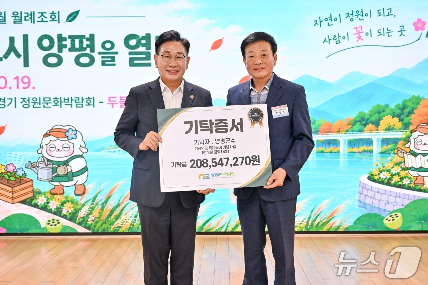 본문 이미지 -  전진선 경기 양평군수(왼쪽)가 고(故) 정희철 전 단월면장의 퇴직연금 기탁증서를 들고 사진을 찍고 있다.(양평군 제공. 재판매 및 DB 금지)/뉴스1