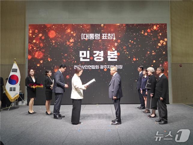 본문 이미지 - 민경본 광주상인연합회장이 9일 충남 공주에서 열린 전국우수시장박람회장에서 대통령 표창을 수상하고 있다. (연합회 제공. 재판매 및 DB금지)