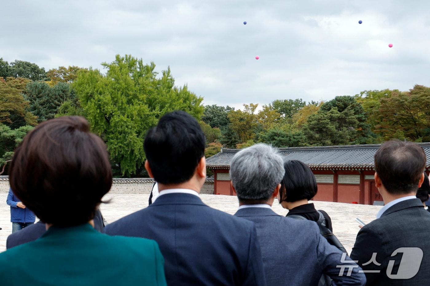 본문 이미지 - 국회 문화체육관광위원회 국민의힘 조은희 간사와 김석기, 김승수, 윤용근 의원이 15일 오후 서울시 종로구 종묘 정전에서 서울시 관계자에게 세운4구역 재정비촉진사업 개요 및 이격거리, 건축물 높이 실증 등에 대한 설명을 듣고 있다. 뒤로 보이는 파란 풍선(141미터, 142미터)과 붉은 풍선(94미터, 99미터)은 사업 대상지 높이다. 2026.10.15 ⓒ 뉴스1 박정호 기자