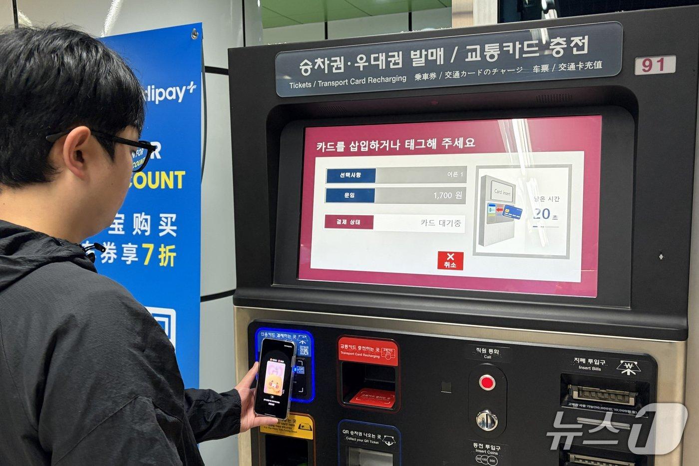 본문 이미지 - 21일부터 부산도시철도 승차권 자동발매기에서 신용카드 및 간편결제 서비스가 도입된 가운데, 한 시민이 스마트폰을 이용해 1회용 승차권을 구매하고 있다. (부산교통공사 제공. 재판매 및 DB금지)