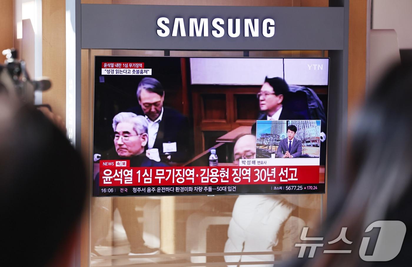 본문 이미지 - 19일 오후 서울역 대합실에 설치된 TV를 통해 윤석열 전 대통령의 내란 우두머리 혐의 1심 선고가 생중계 되고 있다. 윤 전 대통령은 2024년 12월 3일 비상계엄을 선포한 지 443일 만에 무기징역을 선고받았다. 2026.2.19 ⓒ 뉴스1 구윤성 기자