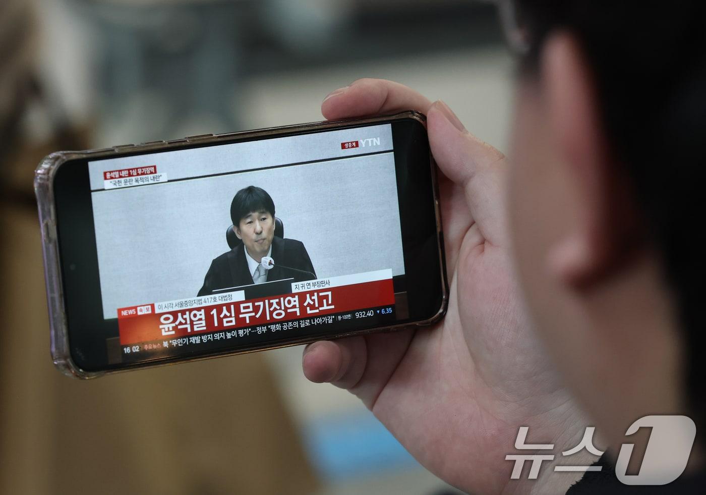 본문 이미지 - 19일 오후 대전역 대합실에서 시민들이 윤석열 전 대통령의 내란 우두머리 혐의 1심 선고 생중계를 시청하고 있다. 윤 전 대통령은 서울중앙지방법원 1심에서 무기징역을 선고받았다. 2026.2.19 ⓒ 뉴스1 김기태 기자